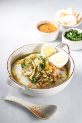 Bubur Ayam or Indonesian Rice Porridge with Shredded Chicken, cheese stick and cakwe.