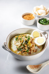 Bubur Ayam or Indonesian Rice Porridge with Shredded Chicken, cheese stick and cakwe.