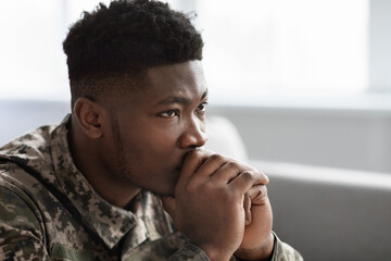 Thoughtful military black man staring at copy space, side view