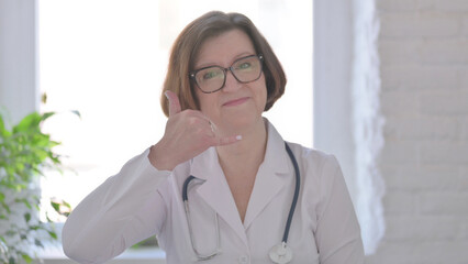 Senior Female Doctor Showing Call me Sign