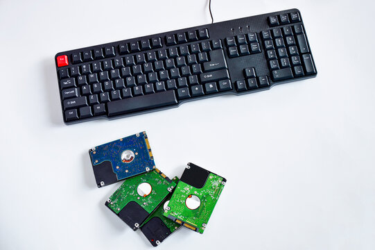 2.5-inch hard drive, swivel plate and keyboard keys on a white background