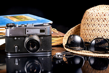 Fototapeta na wymiar Photo album, camera, hat and glasses travel memories
