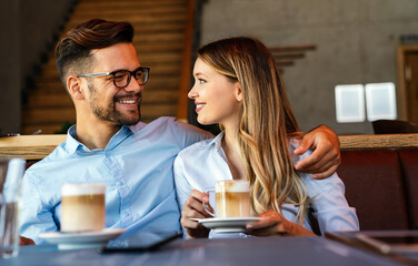 Romantic loving couple drinking coffee, having a date in the cafe.