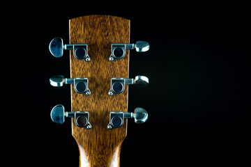 Acoustic Guitar Peg Head Rear View on a Black Background