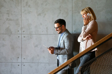 Diverse business people colleagues laughing having fun with digital gadgets in office.