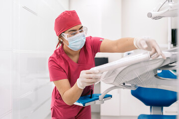 Female Dentist Using Equipment