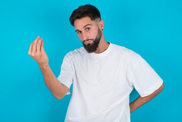 What the hell are you talking about. Shot of frustrated bearded caucasian man gesturing with raised hand doing Italian gesture, frowning, being displeased and confused with dumb question.