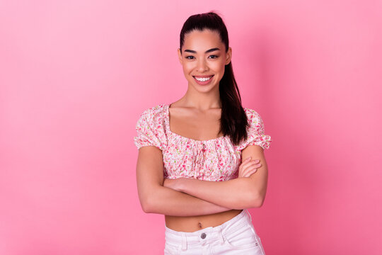 Portrait of gorgeous satisfied filipino person crossed arms beaming smile isolated on pink color background