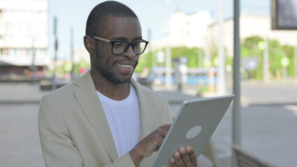 Portrait of African Man using Digital Tablet Outdoor