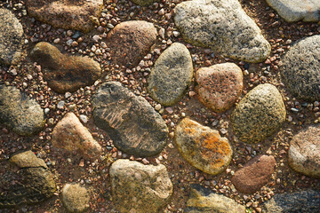 Stone pavement texture. Abstract background of cobblestone pavement close-up. Seamless texture. Perfect tiled on all sides.