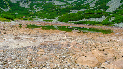 High Tatras mountains in Slovakia. A mountain lake has disappeared, a hot summer in the mountains. Beautiful mountain pass overlooking the lake