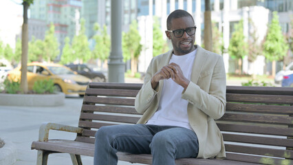 Fototapeta premium Tense African Man Feeling Frustrated while Sitting Outdoor on Bench