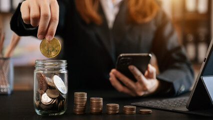 Hand putting mix coins and seed in clear bottle and business investment growth concept. at office.