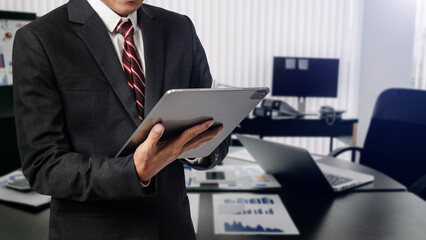 Close up image of business man holding a digital tablet online banking, internet network communication concept in office