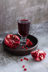 Pomegranate and pomegranate juice on a earthenware 
