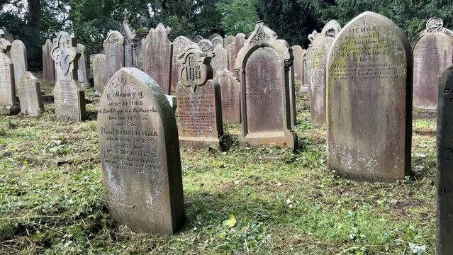 Footage of old gravestones at St Michael and All Angels Church Graveyard. The church is the last resting place of the Bronte family. Haworth England.