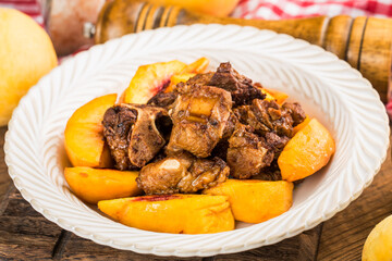 A delicious roast pork ribs with yellow peach