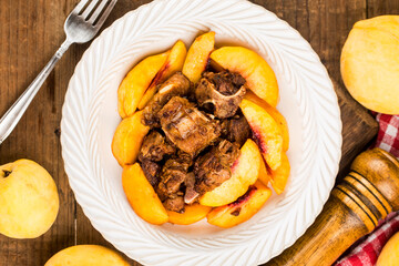 A delicious roast pork ribs with yellow peach