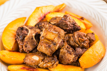 A delicious roast pork ribs with yellow peach