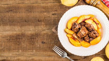 A delicious roast pork ribs with yellow peach