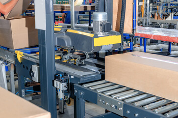 Cardboard packaging machine. Production line of packaging. Industry.