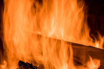 In traditional firewood oven for wood fired pizza, a flame is blazing from the fire which is...