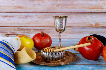 Orthodox traditional holiday New Year symbols of Rosh Hashanah display a bowl honey, shofar,...
