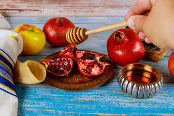 Kosher fruit, pomegranates, apples a honey jar that symbolizes the traditional holiday Jewish New...