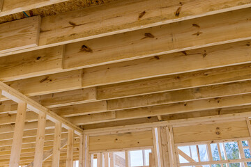 The wooden beams sticks that being used to build a new house are being installed
