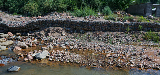Fototapeta na wymiar A stone dam on the water's edge