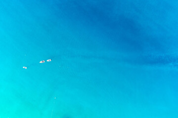 Fototapeta na wymiar Drone aerial photo of sailing boats in open mediterranean turquoise azure sea. Top view