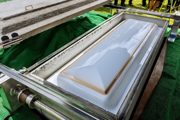 An automatic elevator is used to lower the coffin into a grave by means of funeral service in a cemetery