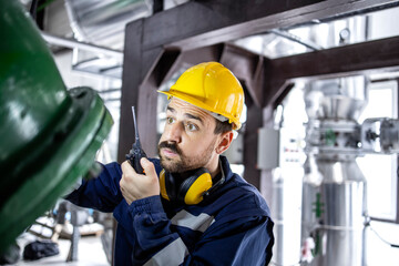 Heating plant employee checking water temperature during winter season.