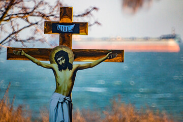 The crucifixion of Jesus Christ on the cross against the backdrop of the sea and ships