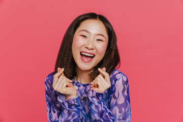 Young cute asian girl with opened mouth showing money gesture