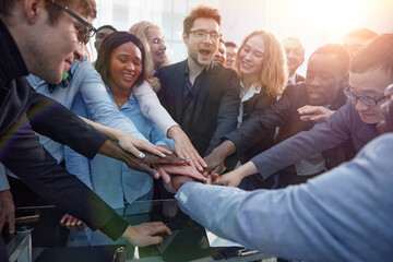 Business team stacking their hands together