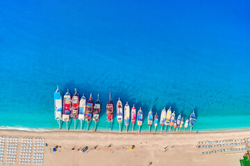 Drone aerial photo of boats on the coast of mediterranean turquoise azure sea. Top view