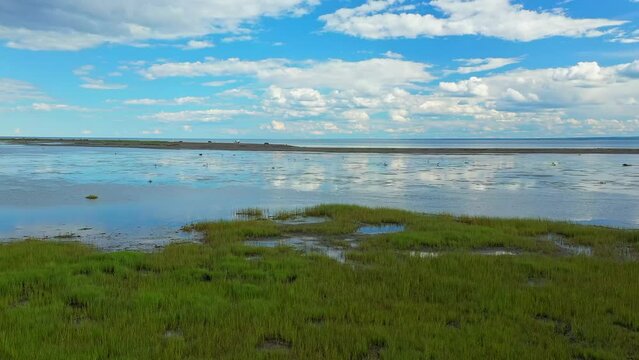 Aerial drone video, at low altitude, panning over the shore at the Parc de la Grande Envol&eacute;e in Carleton sur mer in the Baie des Chaleurs in Gaspesie