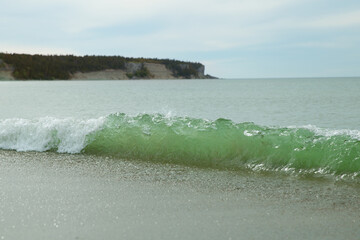 Waves on the sand beach on the island Baltic sea  - 528951821