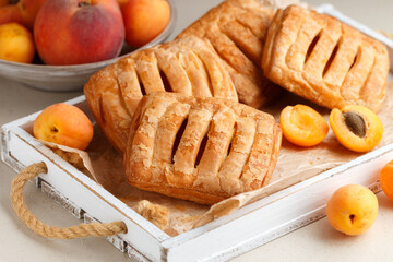 Homemade mini pies made of puff pastry with peach and apricots. Breakfast. Healthy dessert. Selective focus