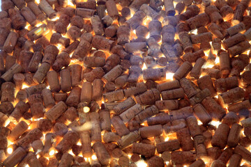 Glass desk with glares of reflected light filled out of vine corks. Selective focus