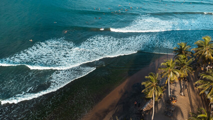 Beautiful view of the sea and the ocean with surfers waiting for the waves.
