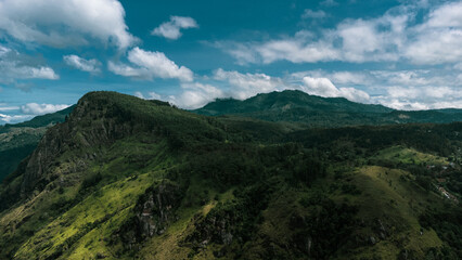 Naklejka na ściany i meble Beautiful mountain landscape with green mountains and blue sky.