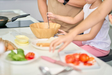 Girl try to cooking with tuna can in wood bowl for make sandwich in kitchen