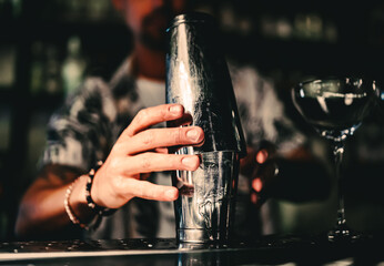 steel shakers stand on the bar counter