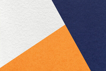Texture of craft navy blue, white and orange shade color paper background, macro. Vintage abstract indigo cardboard - obrazy, fototapety, plakaty