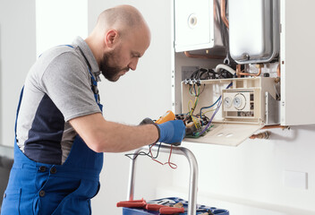 Qualified engineer servicing a boiler