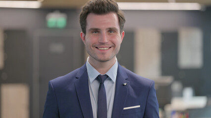 Naklejka premium Portrait of Attractive Businessman Smiling at Camera