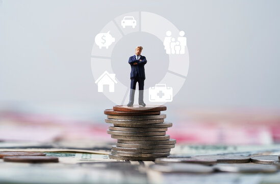 Businessman Standing On Coins Stacking With Donut Chart And Insurance Icons Include Family Healthcare House Piggy Saving And Car For Risk Management Concept.