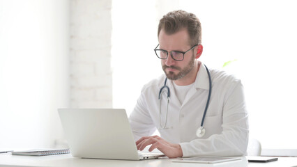 Fototapeta premium Doctor Working on Laptop in Clinic